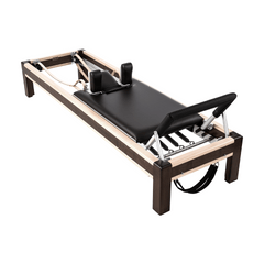 80" Walnut and Maple Reformer with full accessories, including straps, handles, and reformer box for diverse Pilates exercises.