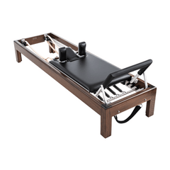 86" and 89" Walnut Reformers equipped with reformer box, ergonomic handles, foot straps, and stainless steel pole, offering an all-in-one Pilates solution.